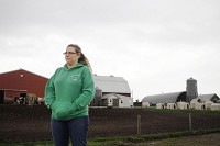 Dawn Wolfe stands on her 265-acre family farm in Hebron which they may have to abandon due to a proposed Great Lakes Basin Rail Line that would cut through their property. Staff photo by Suzanne Tennant