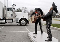 A Seward Johnson statue of mariachi singers stands near the truck that delivered it and 10 other statues at the Crown Point Sportsplex.. Staff photo by Suzanne Tennant