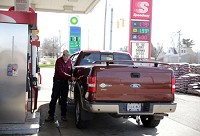 Bob Solivais of Griffith pumps gasoline recently at the Speedway in Griffith, where a gallon of regular was going for $1.79. Staff photo by Jonathan Miano
