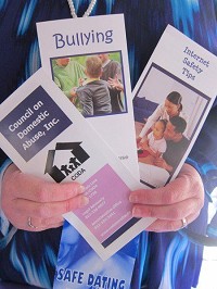 Some of these pamphlets with information about healthy relationships, domestic violence and CODA. Staff photo by Lisa Trigg