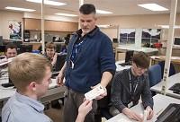Instructor Jeff Lindke, center, takes a phone case Jacob Hochstetler, left, designed to hold a pair of earbuds in the case Tuesday, March 8, 2016 at the Elkhart Area Career Center. (Elkhart Truth photo/Amanda Wilkinson) 