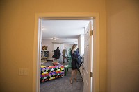 Jamie Irwin tours a one-bedroom model apartment at the Hoffman Hotel Apartments on Wednesday in downtown South Bend. Residents started moving into the renovated artist lofts in mid-march, but Wednesday marked the building's official opening. Tribune photo/BECKY MALEWITZ