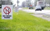 A pair of signs opposing a proposed wind farm in northwestern Henry County stands along U.S. 36 in Sulphur Spring on Monday. Two other winds farms have been proposed in southern Henry County. Staff photo by Don Knight