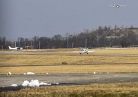 A plane comes in for a landing as others taxi to the runway before taking off at Clark County Airport in this file photo.