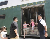 Conductor Steve Kimbley ushers passengers aboard the French Lick Scenic Railway train Saturday afternoon. Staff photo by Garet Cobb