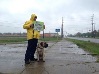 Michael Hinchley, a lead machinest at Honeywell in South Bend, stands with his dog, an English mastiff named Bear, on Tuesday at the corner of North Bendix Drive and Westmoor Street in South Bend. Honeywell locked Hinchley and other members of United Auto Workers Local 9 out of the South Bend plant on Monday after the union rejected the company's new contract offer. Tribune Photo/KEVIN ALLEN