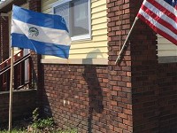The flags of El Salvador and the United States fly outside a Main Street home in Elkhart on April 20, 2016. The woman living there said street gangs in the Central American country make it a tough place to live. (Elkhart Truth photo/Tim Vandenack)