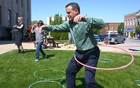 Tyler Moore tries out the hula hoop at Adult Recess Thursday. The United Way of Howard County is sponsoring the weekly event between 11 a.m. and 1 p.m. through Sept. 15. Staff photo by Tim Bath