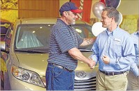 Toyota Indiana employee Greg Byram (left) hands a set of keys to a 2016 Toyota Sienna to Brian Kerney, executive director at Aurora, during the Toyota Indiana 20th anniversary celebration at the visitors center in Princeton onWednesday. Byram was one of the members of the first production crews at the plant. Staff photo by Jason Clark