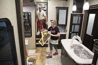 Gabi Routson does finishing work on a Grand Design RV in Middlebury in this file photo. A recent study found Indiana's 2nd Congressional District, with Elkhart at the epicenter, received the lion's share of the economic benefit generated by the RV industry. Tribune Photo/SANTIAGO FLORES