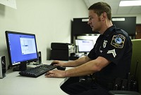 Clarksville Police Cpl. Wayne Townsend organizes files after download body cam footage to the department computer. Staff photo by Tyler Stewart