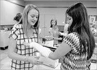 Claire O&rsquo;Reilly of Evansville (left) applies a plaster splint on the arm of Katelyn Dougan of Chandler while taking part in the Deaconess Health Science Institute at Johnson Hall on the main campus of Deaconess in Evansville Tuesday. Staff photo by Jason Clark