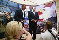 U.S. Secretary of Defense Ashton Carter, left, and U.S. Sen. Joe Donnelly, D-Ind., answer questions from the media during their visit Wednesday to Crane Naval Surface Warfare Center. Staff photo by Jeremy Hogan