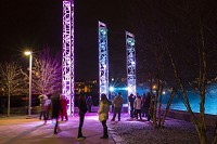 The South Bend River Lights, which was installed last year on the cascade of the St. Joseph River, have succeeded in attracting people to the downtown riverfront at night. This photo was taken in February on the island next to Century Center. Staff photo by Greg Swiercz