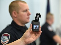 Jeffersonville Police Cpl. Todd Wilson holds a body camera his department's police officers started wearing in May 2014 in this file photo. Staff file photo by Tyler Stewart
