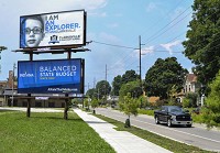 A billboard advertisement for Clarksville Elementary School stands over Main Street near downtown New Albany. Staff photo by Tyler Stewart