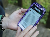 Resident Deborah Rowley uses the nextdoor app on her smartphone to monitor activity Thursday, July 7, 2016, in the Columbian Park neighborhood. Staff photo by John Terhune