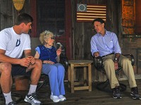 Evan Bayh and his son, Beau, share stories with Sue Secondino at the Bayh homestead in Shirkleville, which is near Terre Haute. Secondino now owns the farmhouse that Bayn and his son visited in late May 2016. Staff file photo by Austen Leake