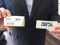 Indiana Department of Transportation spokesman Will Wingfield holds two different types of RiverLink transponders, Staff photo by Elizabeth Beilman