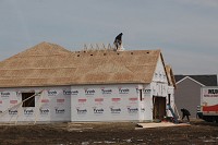 A construction workers sets rafters on a home being built by Providence Red in the Regency&nbsp; single-family Crown Point earlier this year. Staff photo by Tony V. Martin