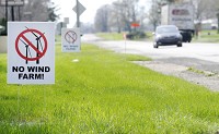 A pair of signs opposed to a proposed wind farm in northwestern Henry County stand along U.S. 36 in Sulphur Springs in April 2016. Staff photo by Don Knight
