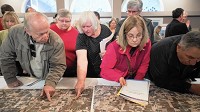 Visitors look at a map of a proposed rail line through Porter County on Tuesday, April 12, 2016, during a public meeting with the Surface Transportation Board in Valparaiso.&nbsp; Staff photo by Kyle Telechan