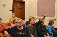 Hands up: Many concerned county residents waited patiently for their turn to speak up at the Area Plan meeting on Monday where the wind farm ordinance was discussed. Staff photo by Leeann Doerflein