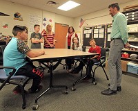 Fifth-grade students, their principal and teacher at Model Elementary School talk with Goshen Mayor Jeremy Stutsan about what they intend to do with $1,750 the mayor donated to the fifth grade Monday as part of his Year of Goodness campaign. Staff photo by Roger W. Schneider