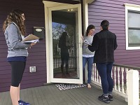 University of Notre Dame students Annie Dempsey, left, and Danielle LeFleur, right, speak with Kate Appel about lead poisoning Saturday as part of a 'Get Out the Lead' event in the Near Northwest Neighborhood in South Bend. Staff photo by Erin Blasko