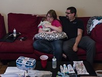 Ashley McReynolds and her husband Kyler McReynolds take care of their new foster baby at their home in Newburgh, Ind., on Friday, June 16, 2017. The couple received a call asking if they would be willing to care for the baby on June 1, the day before their ten year wedding anniversary, while they were on vacation in New York City. Staff photo by Sam Owens