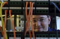 Ivy Tech Community College student David Houchin says he sees today's hackers and cybercriminals equivalent to the outlaws of the Old West. Here, Houchin poses for a photo between network raacs in one of the classrooms on the Ivy Tech Wabash Valley campus on Wednesday, June 21, 2017. Staff photo by Joseph C. Garza