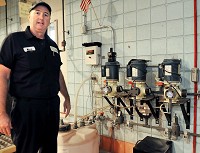 Alexandria Water Department Superintendent Mark Caldwell shows the fluoride system, when he turned off in 2008, with three pumps for each of the city's wells. Staff photo by John P. Cleary