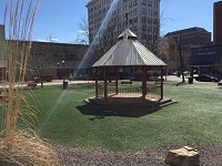 The artificial turf-covered park on Main Street is an example of Downtown areas that could be enhanced by using a Economic Improvement District, advocates for the EID said. Staff photo by John Martin, Courier &amp; Press)