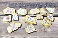 Displayed are a few of the golden rocks with traditional barn quilt patters that may be found at local parks and other area tourist attractions. Staff photo by Quiche Matchen