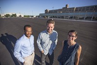Aaron Vernon, from left, Dustin Mix and Maria Gibbs pose in front of Building 113, part of the former Studebaker complex, on Tuesday in South Bend. All three are with Invanti, a startup social venture that seeks to catalyze aspiring entrepreneurs to solve big problems. Staff photo by Santiago Flores