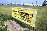 NOT ENOUGH WORKERS: A sign in front of the Dollar General distribution center near I-69 advertises open interviews for jobs. Though there are opening across the county, the available workforce dwindles due to lack of skills and decreasing population. Staff photo by Jeff Morehead