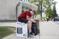 Ryan Goldman waits with his brother's items outside Wilke South on the IU Bloomington campus, Aug. 15, 2017. Staff photo by Jeremy Hogan