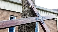 A crucifix that was carried through the streets of East Chicago last Good Friday waits for the stations of the cross to begin. (Jim Karczewski / Post-Tribune)