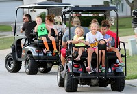 A group of Hobard neighbors travel to Dairy Queen in their golf carts Wednesday in Hobart. Staff photo by Jonathan Miano
