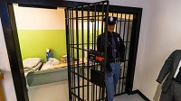 A officer guards a replica jail cell in the John Dillinger Museum where John Dillinger spent his time after being arrested. (Jim Karczewski/Post-Tribune)