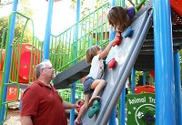 Bill Slonaker supervises his two granddaughters, Izabella and Sopheira Winterroad, as Izabella ascends climbing wall at Highland Park in Kokomo on Aug. 30, 3017. The Slonakers have taken over as day-to-day guardians of their grandchildren. Staff photo by Kelly Lafferty Gerber