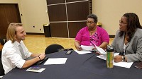 Teaching candidate Brad Mautz is interviewed Wednesday by Yvonne Lucas, center, and Melisha Jones-Anderson during a recruitment fair sponsored by the Gary Community School Corp. at Purdue Northwest in Hammond.&nbsp; (Carole Carlson / Post-Tribune)