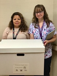 Gabriela Trejo, Breastfeeding Peer Counselor (left) and Renee Hagen, Registered Dietitian (Right) are shown displaying the baby boxes given out at Elkhart General Hospital by the Elkhart County Health Department. Provided photo
