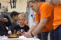 Club members and ArcelorMittal volunteer Tyler Botbyl, process manager-annealing, finishing department, ArcelorMittal Burns Harbor, designs mini bows and arrows at the Valparaiso club&rsquo;s first STEM Expo. The steelmaker is giving local schools STEM grants. Provided photo