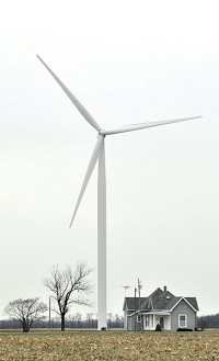 A wind turbine dwarfs a nearby home near Curtisville, southeast of Kokomo on Wednesday, Dec. 13, 2017. Staff photo by Kevin Burkett