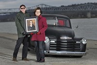 Robert Feltner and Teresa Waller: At Ohio Riverfront Park in Madison, Alex Feltner's parents stand with a picture of their son in front of the 1947 Chevrolet truck the father and son resotre. Waller channels her grief into service work for teens and young adults. Not Feltner: "'I'm not going to be like his mother and combat this. It's too late," Feltner said of losing Alex to the opioid epidemic. Instead, he drives his truck to a memorial for Alex along the riverfront, parks and sits for hours. Staff photo by Chris Howell