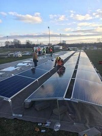 Workers install solar panels at Warsaw Community Schools. Courtesy image