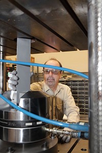 Senior technician Greg Volk sets up a sample of high-strength automotive steel for a draw bead test at the ArcelorMittal Global R&amp;D facility in East Chicago. R&amp;D spending in Indiana rose in 2015. Staff photo by Tony V. Marin