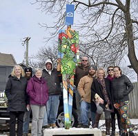 Community garden stakeholders: Employees of John Lasley Outdoor Solutions and Boone County Community Foundation pose Friday, Feb. 9, 2018, for thefirst photo of the last Walking Man statute placed in Lebanon. Staff photo by Leeann Doerflein