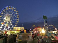 Food booths and rides light up the night sky at the Elkhart County 4-H Fair in this July 2014 file photo. Last week the fair board unveiled a 25-year master plan to help guide growth of the county fair, one of the largest in the country. Tribune File Photo/MARSHALL V. KING